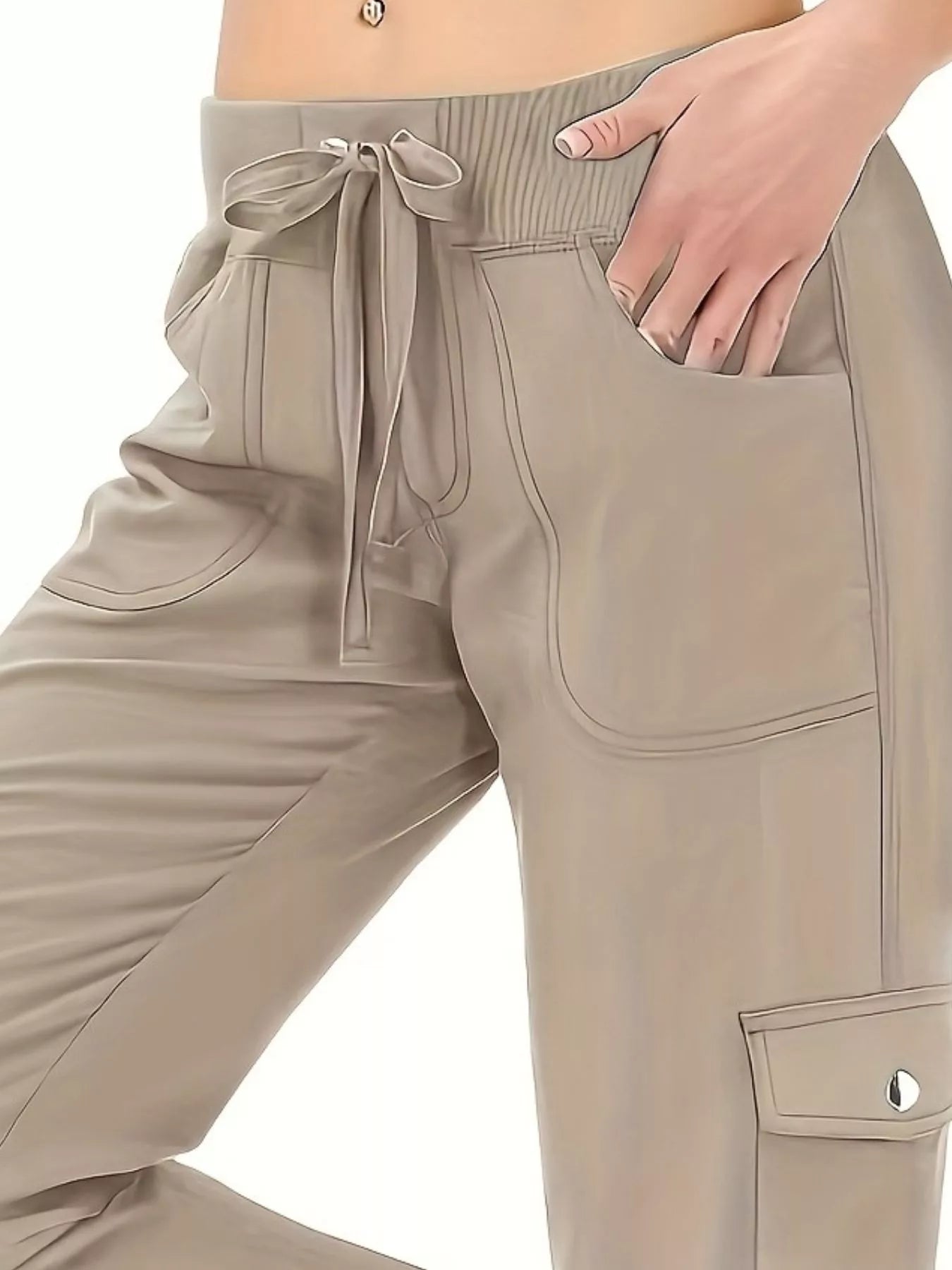 Beige cargo pants with a drawstring waist and pockets on a white background