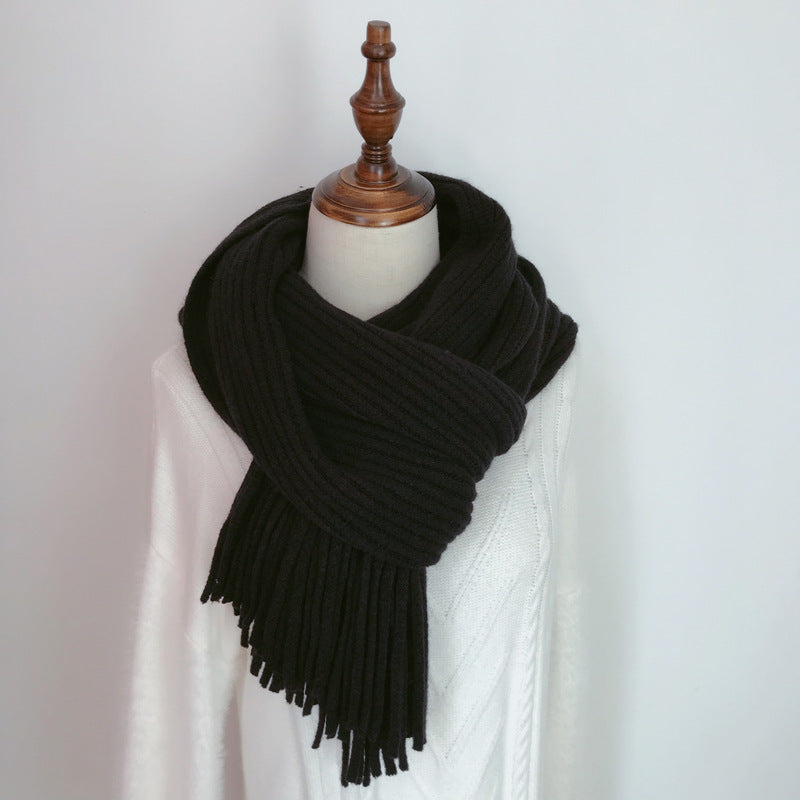 Black scarf with fringe on a mannequin against a white background
