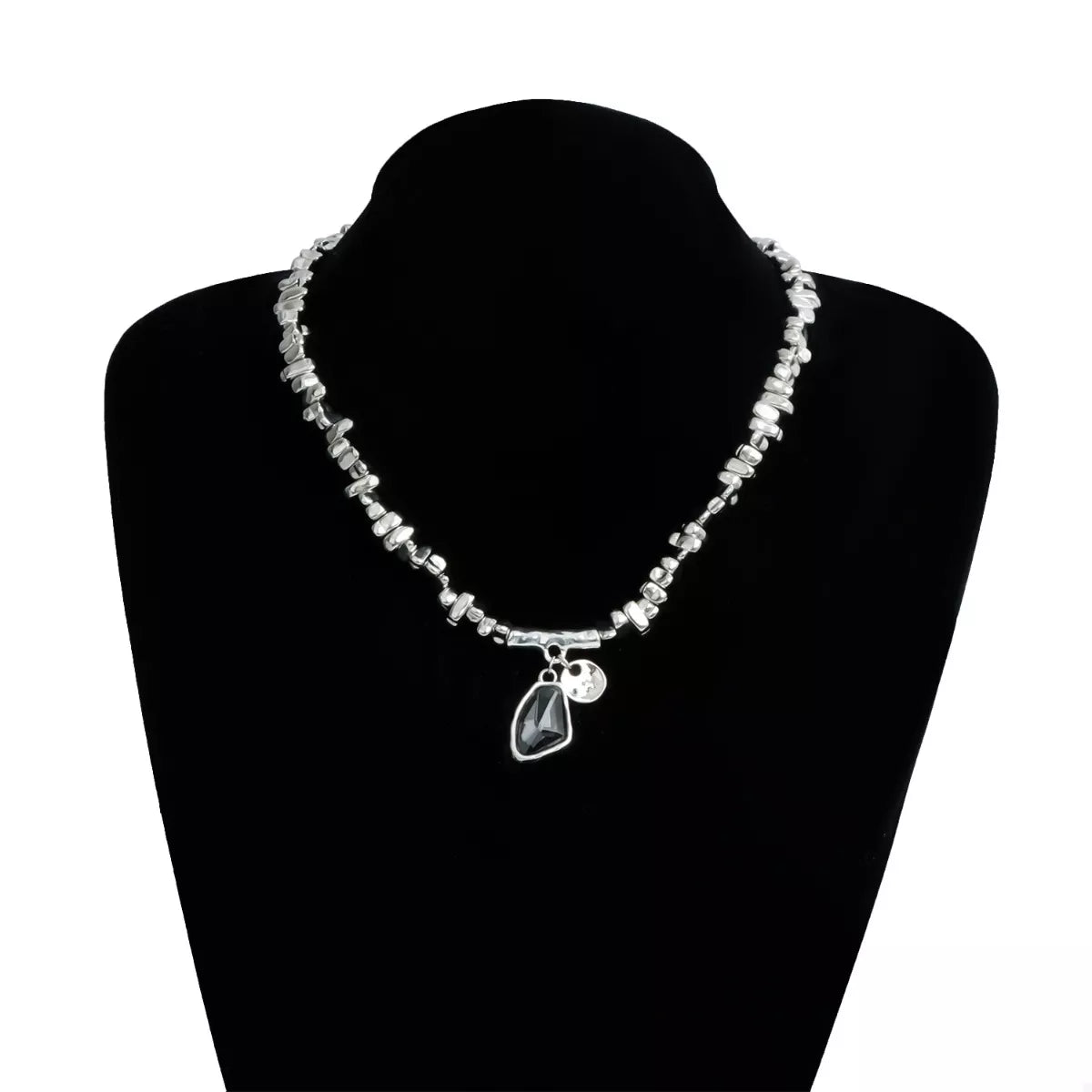Necklace with a pendant on a black mannequin bust against a white background