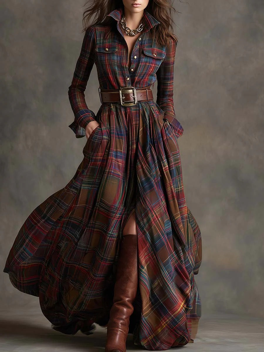 Woman wearing a long plaid dress with a belt and brown boots against a neutral background