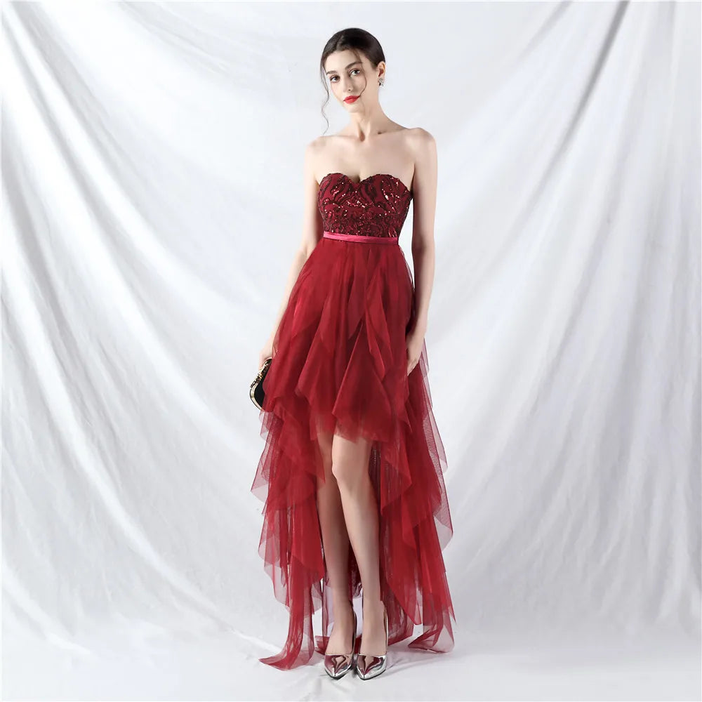Red strapless gown with sequin top and tulle skirt on a white background