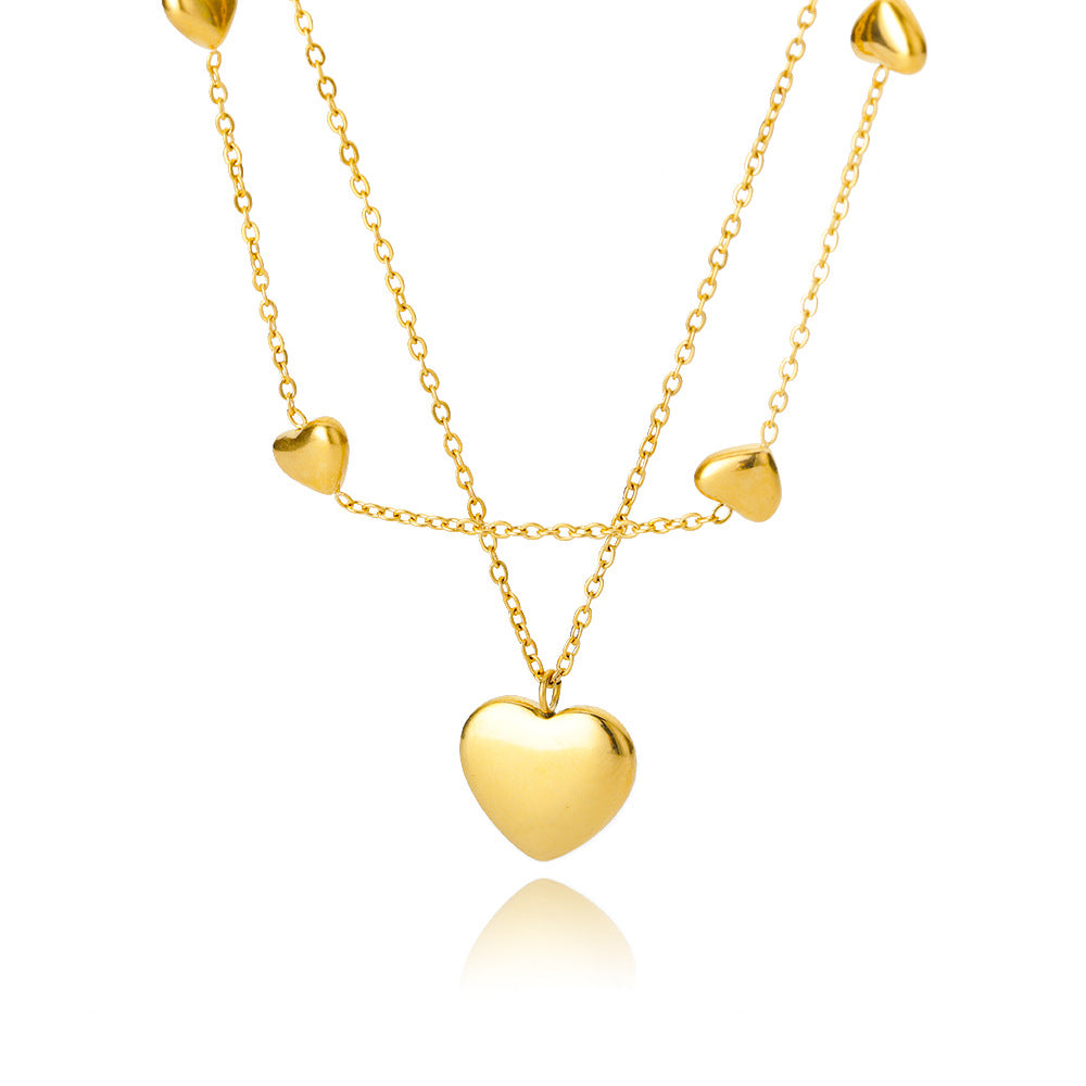 Gold heart-shaped necklace on a white background