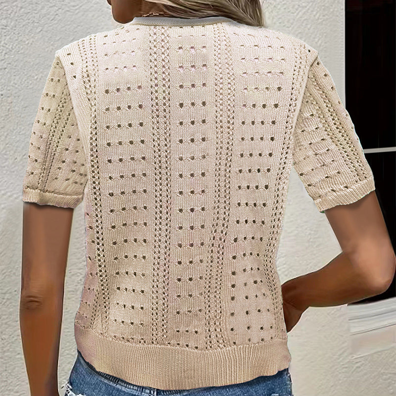 Beige knitted cardigan worn by a person against a neutral background