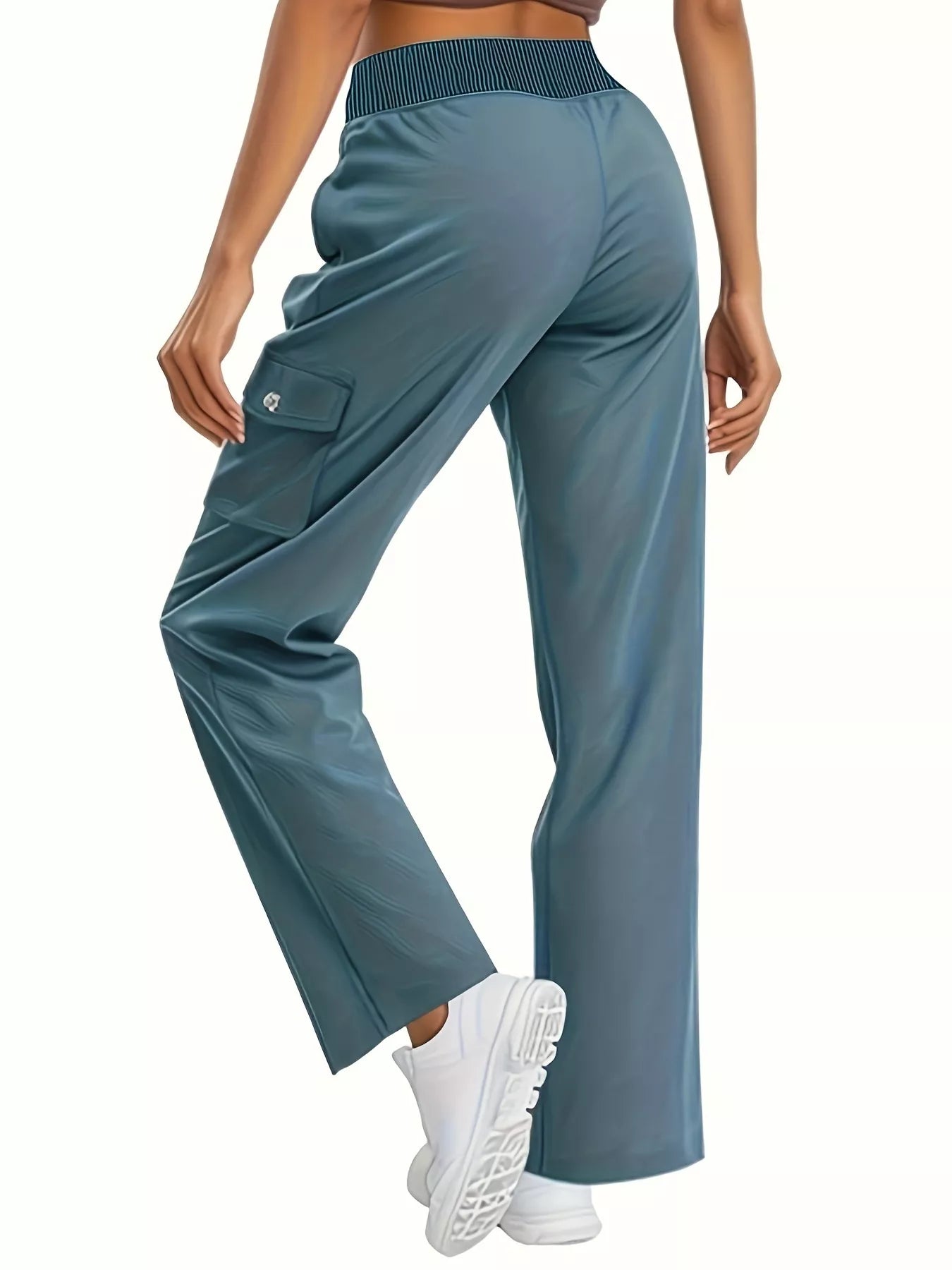 Teal wide-leg pants worn by a person on a white background
