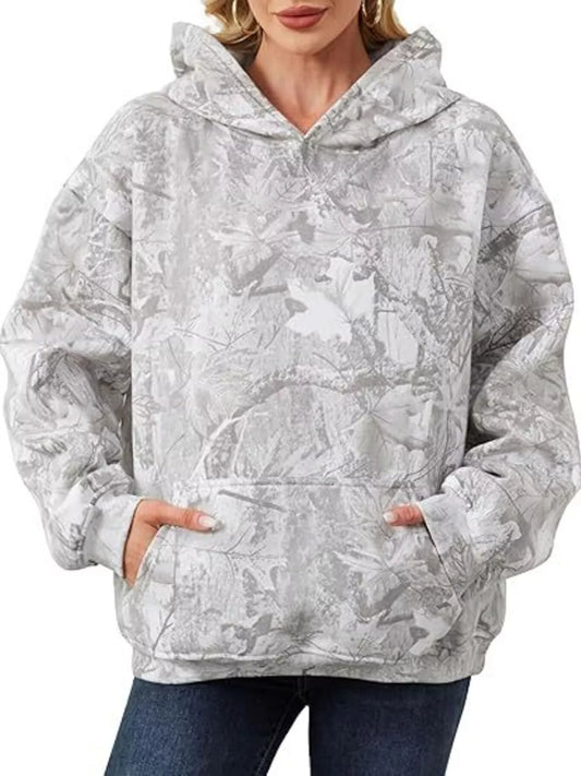 Person wearing a gray camouflage hoodie on a white background