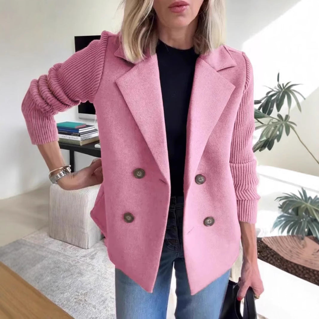 Person wearing a pink blazer in an indoor setting