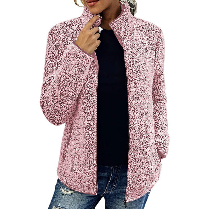 Pink sherpa jacket worn by a person on a white background