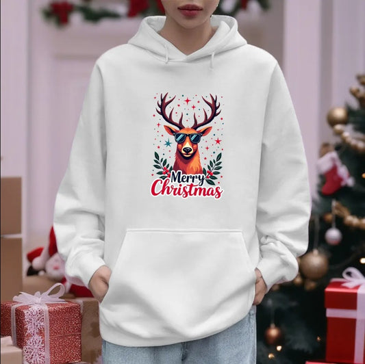 White hoodie with a reindeer design and 'Merry Christmas' text, worn by a person in a festive setting.