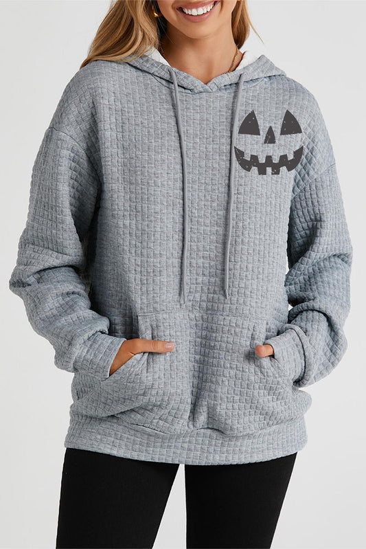 Person wearing a gray textured hoodie with a Halloween-themed design on a white background