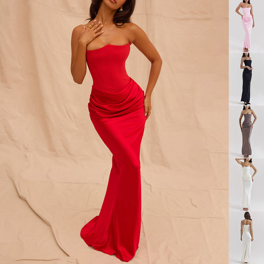 Red strapless gown on a beige background with a side view