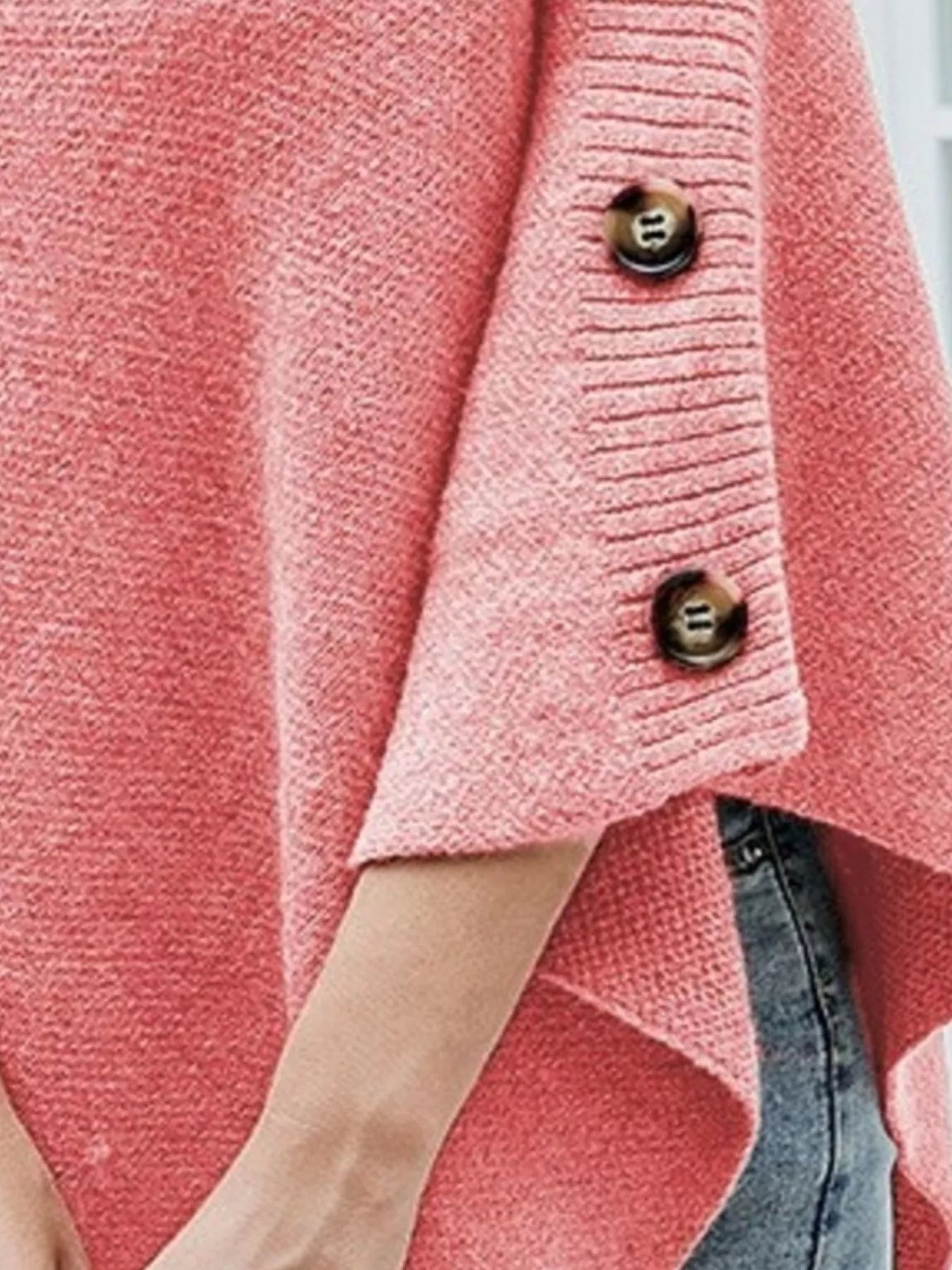 Close-up of a pink textured cardigan with buttons