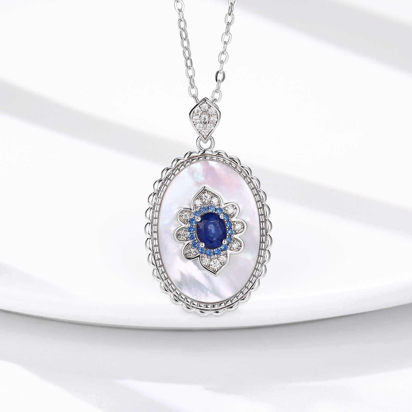Elegant necklace with a pendant featuring a blue gemstone on a white background