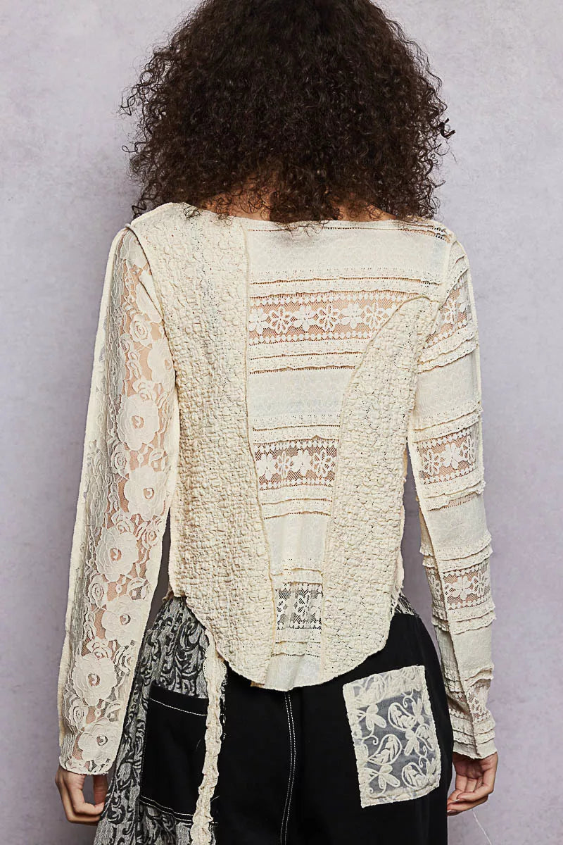 Person wearing a patterned beige jacket with a plain background