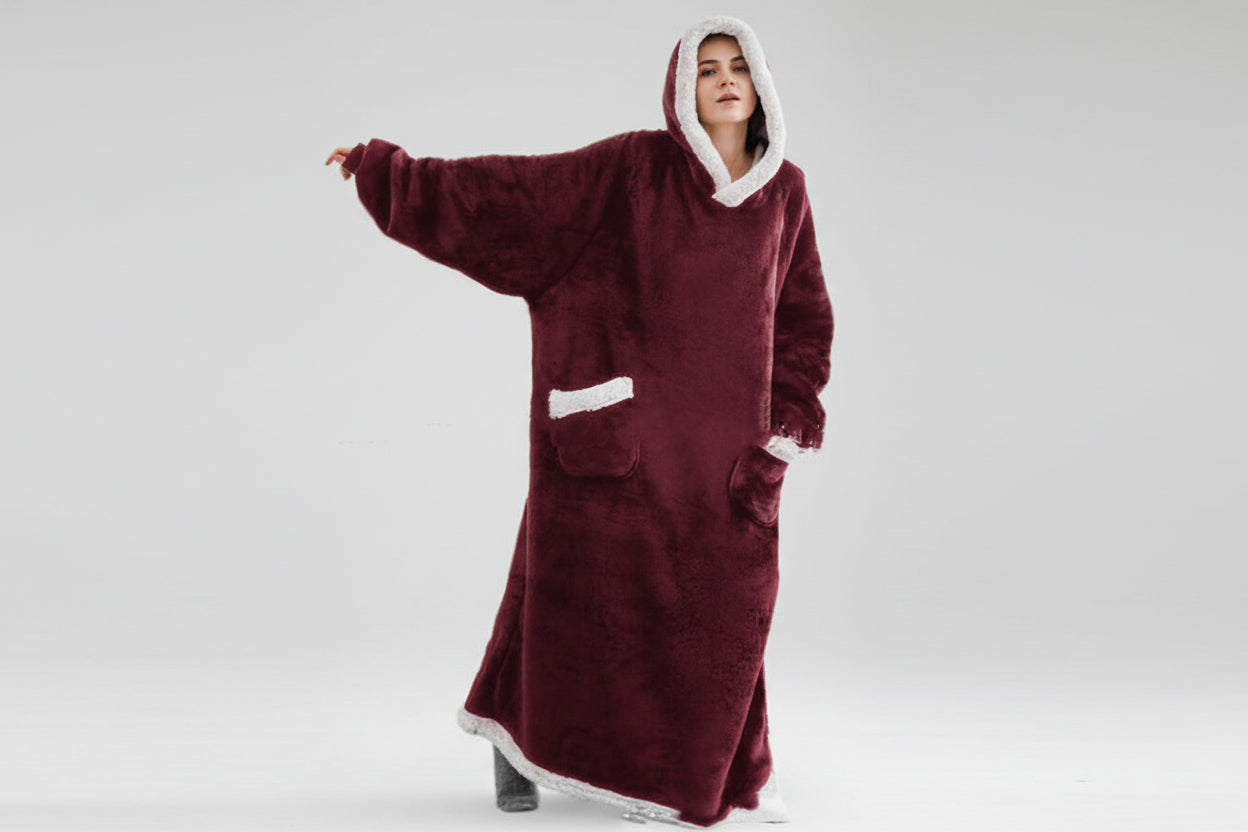 Maroon onesie with white trim worn by a model on a grey background.