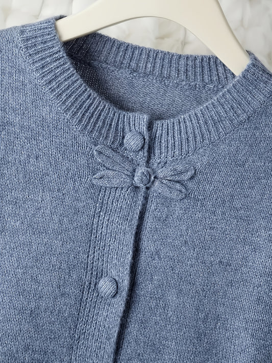 Blue knitted cardigan with button details on a white background