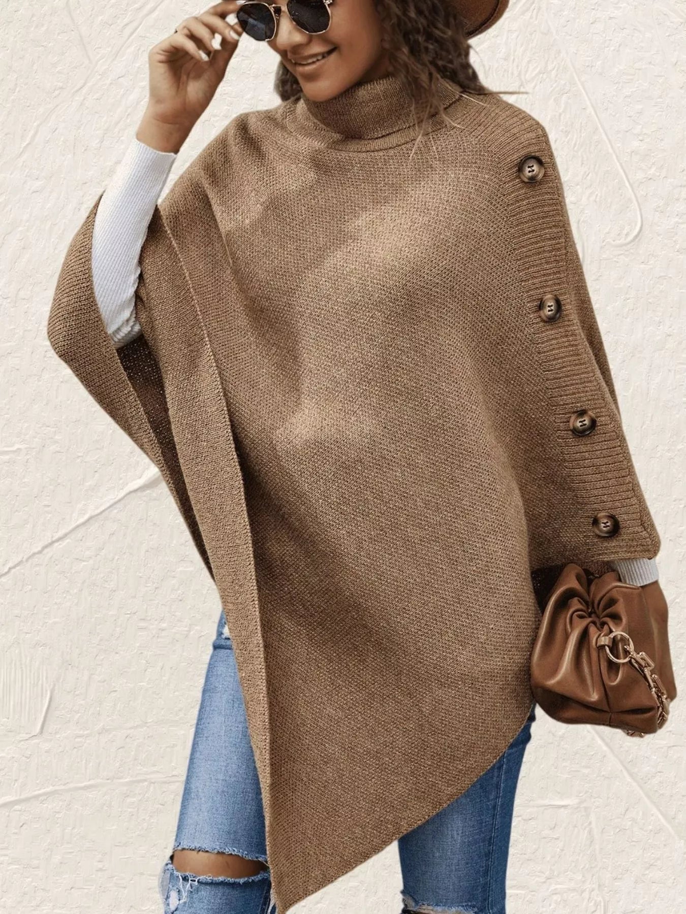 Woman wearing a brown poncho with a neutral background