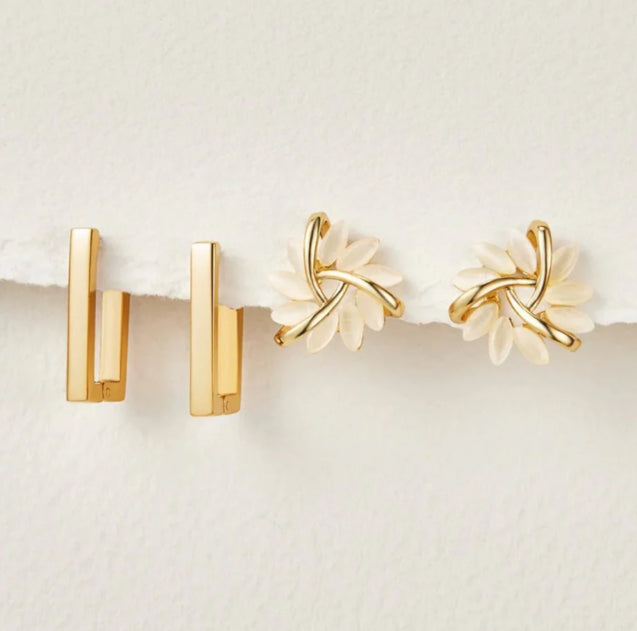 Gold earrings on a white background