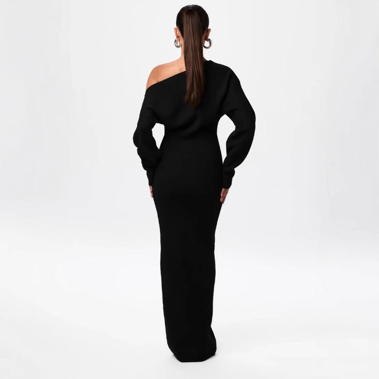 Black off-shoulder dress worn by a person on a white background