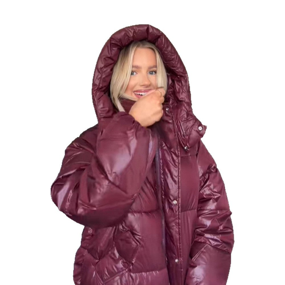 Person wearing a maroon puffer jacket on a white background