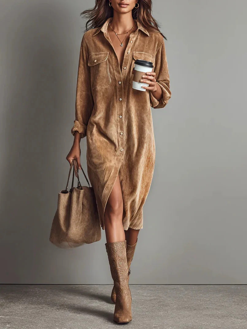 Woman wearing a brown suede dress and boots, holding a handbag and a coffee cup against a gray background.