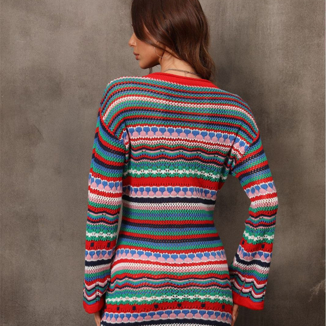 Person wearing a colorful striped sweater against a gray background