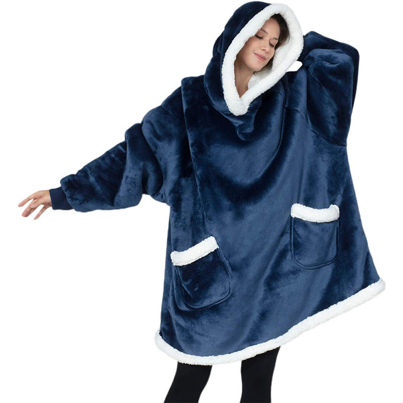 Person wearing a blue hooded poncho with white trim on a white background