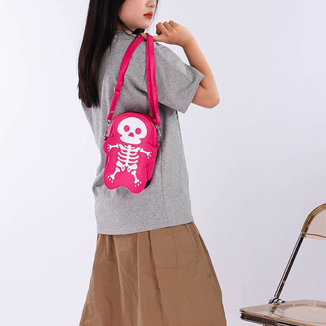 Person wearing a gray shirt and brown pants with a pink backpack featuring a skeleton design on a white background.