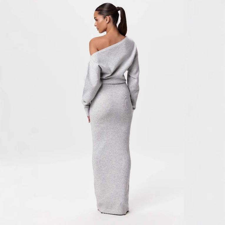Woman wearing a gray off-shoulder dress on a white background