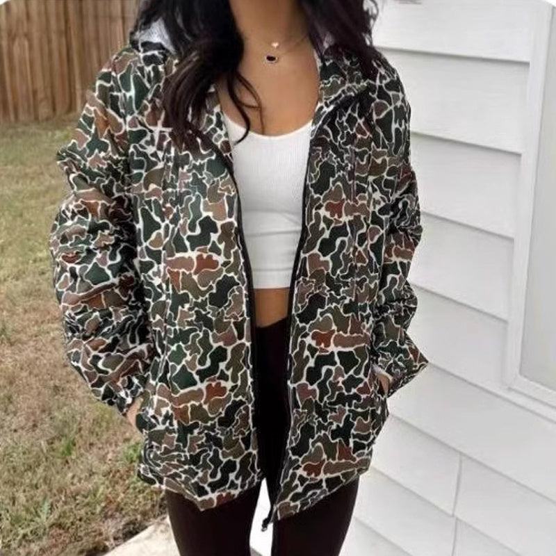 Person wearing a camouflage-patterned jacket outdoors.