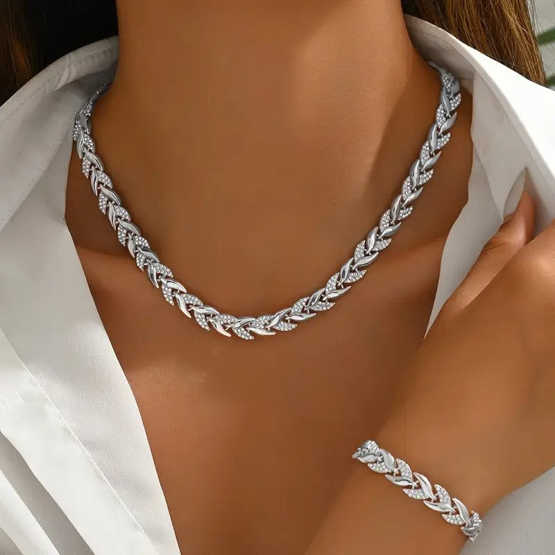 Silver braided necklace and bracelet on a model wearing a white shirt.