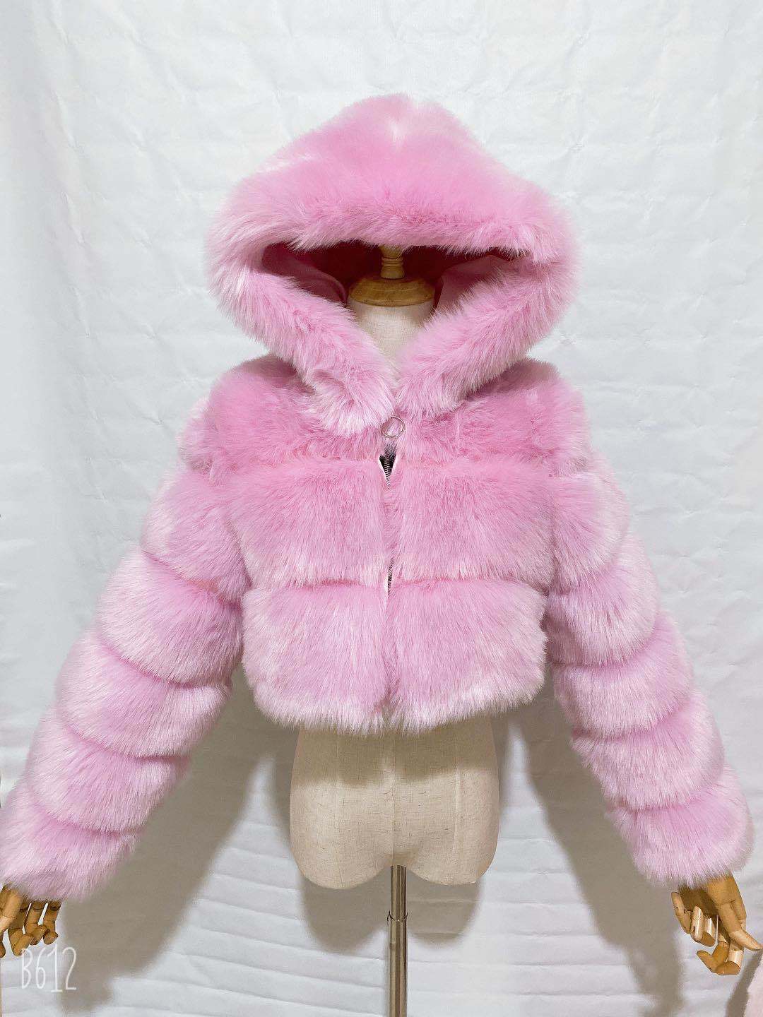 Pink fur coat on a mannequin against a white background