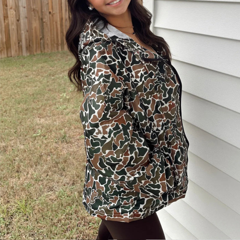 Person wearing a camouflage-patterned shirt outdoors.