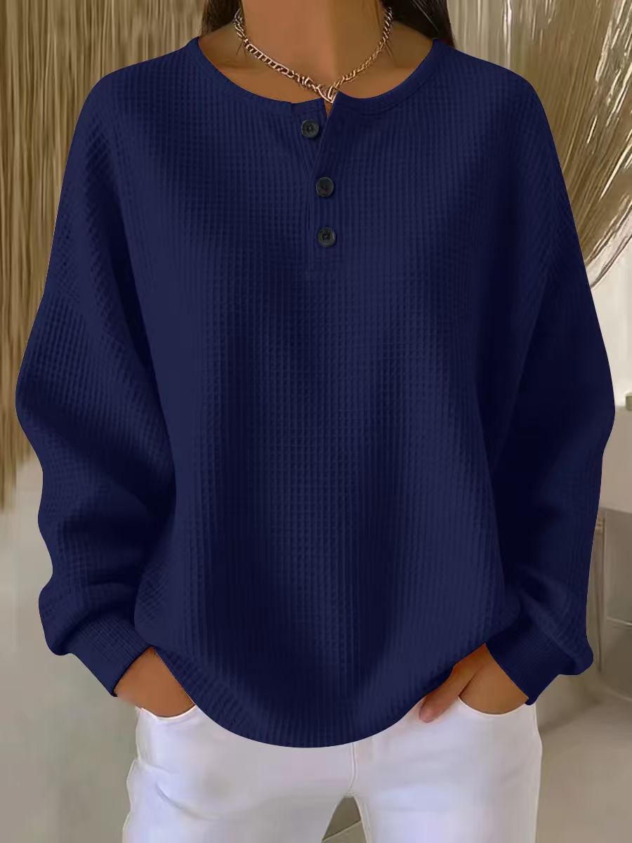 Navy blue sweater worn by a person with a neutral background