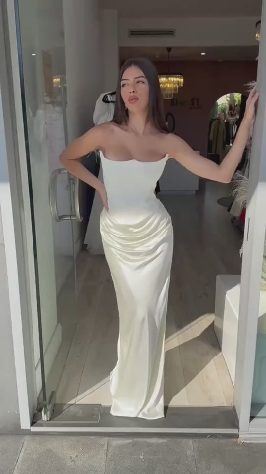 Video of a woman wearing a sleeveless tube top evening gown styled for a sexy and elegant party look.